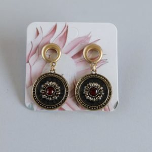 Gold Earrings With Red and Clear Stones Set in a Black Medallion
